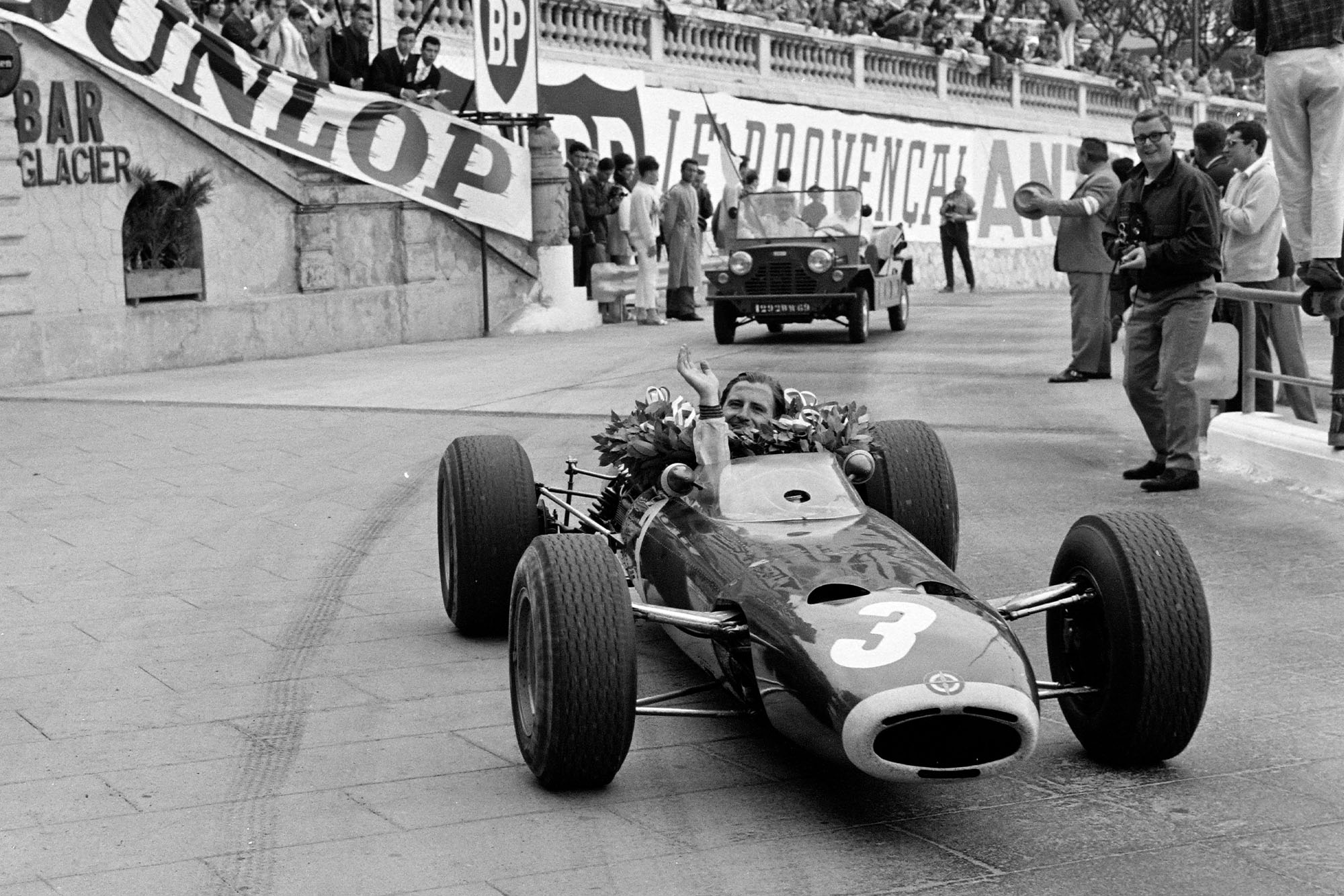 Race winner Graham Hill, BRM P261, drives a victory lap.