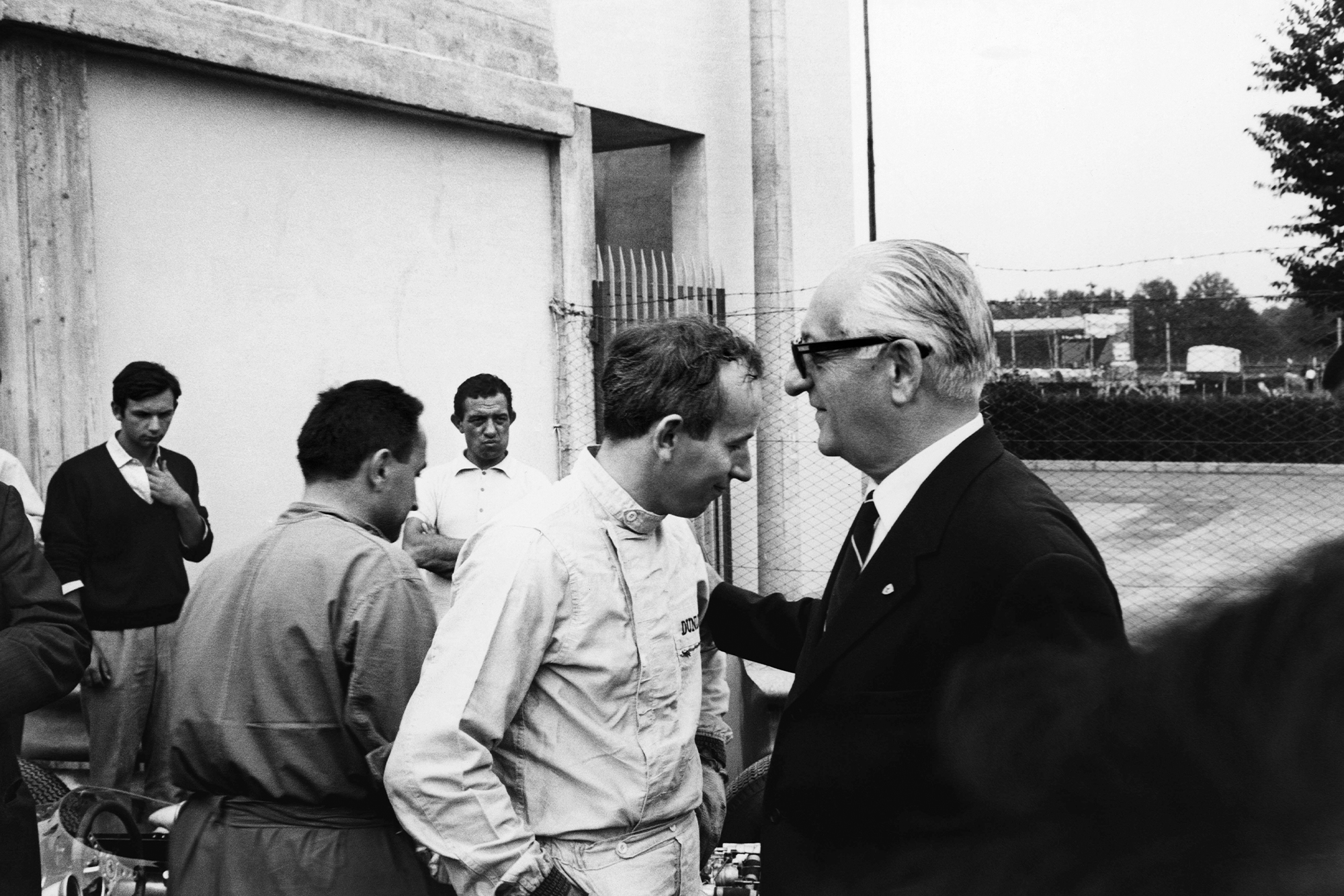 John Surtees with Ferrari team boss Enzo Ferrari talk in the pits.