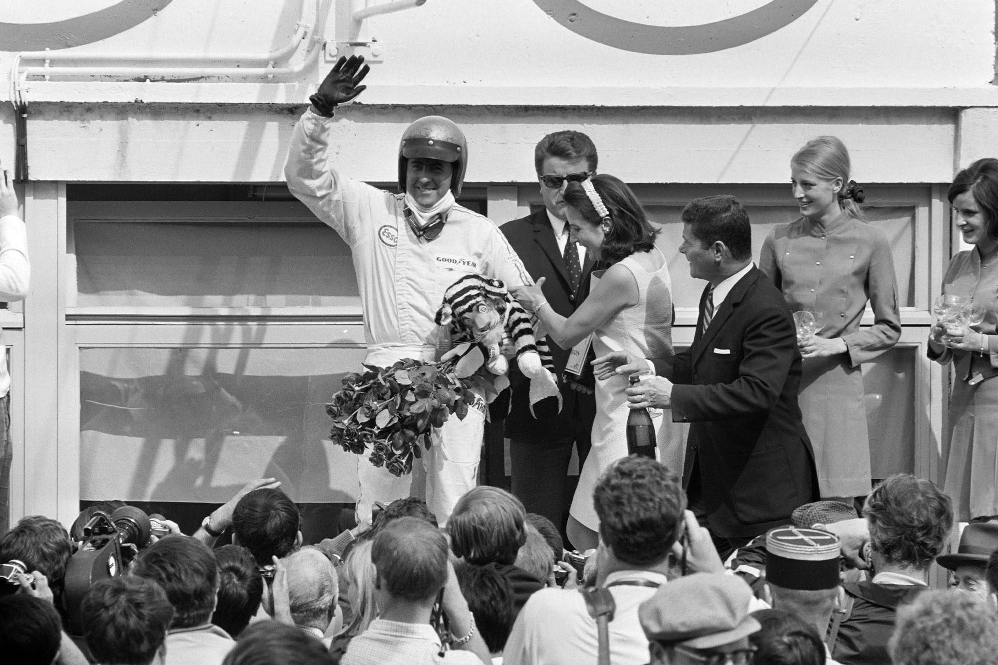 Jack Brabham, 1st position, celebrates on the podium.