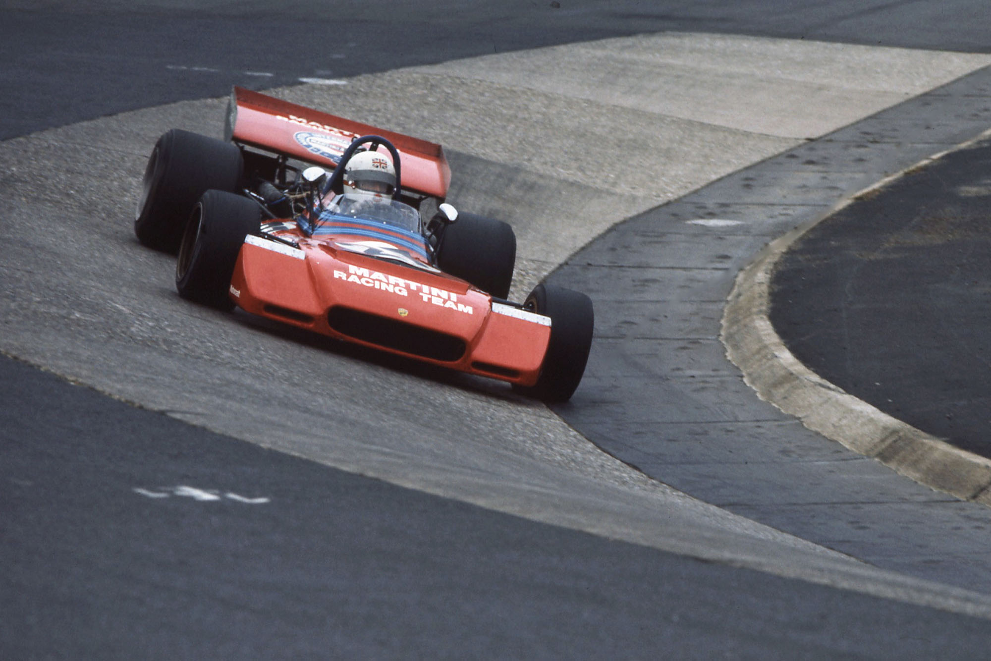 Derek Bell of Great Britain drives the #27 Martini Racing Team Tecno PA123 Tecno Flat-12 through the Karussell during the German Grand Prix on 30th July 1972 at the Nurburgring near Nurburg, Germany. (Photo by Grand Prix Photo/Getty Images)