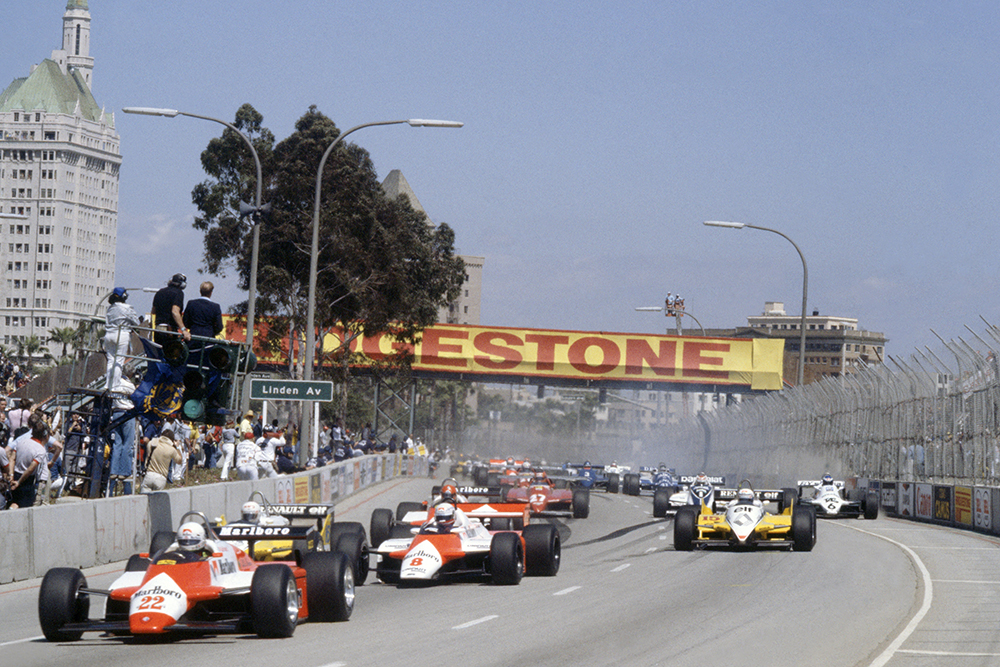 Andrea de Cesaris (Alfa Romeo 182) leads Niki Lauda (McLaren MP4/1B-Ford Cosworth), Rene Arnoux, Alain Prost (both Renault RE30B), Bruno Giacomelli (Alfa Romeo 182), Gilles Villeneuve (Ferrari 126C2), Nelson Piquet (Brabham BT49D-Ford Cosworth) and Keke Rosberg (Williams FW07C-Ford Cosworth) at the start.
