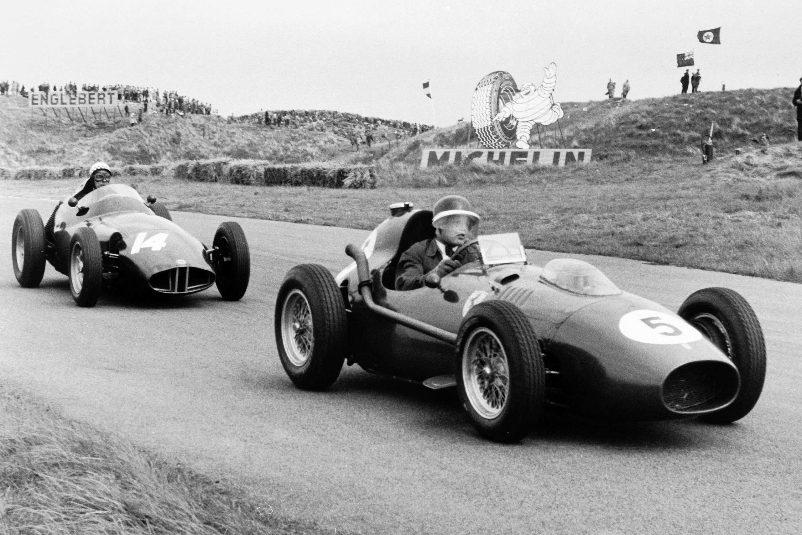 Mike Hawthorn in his Ferrari Dino 246, ahead of Jean Behra in a BRM P25.