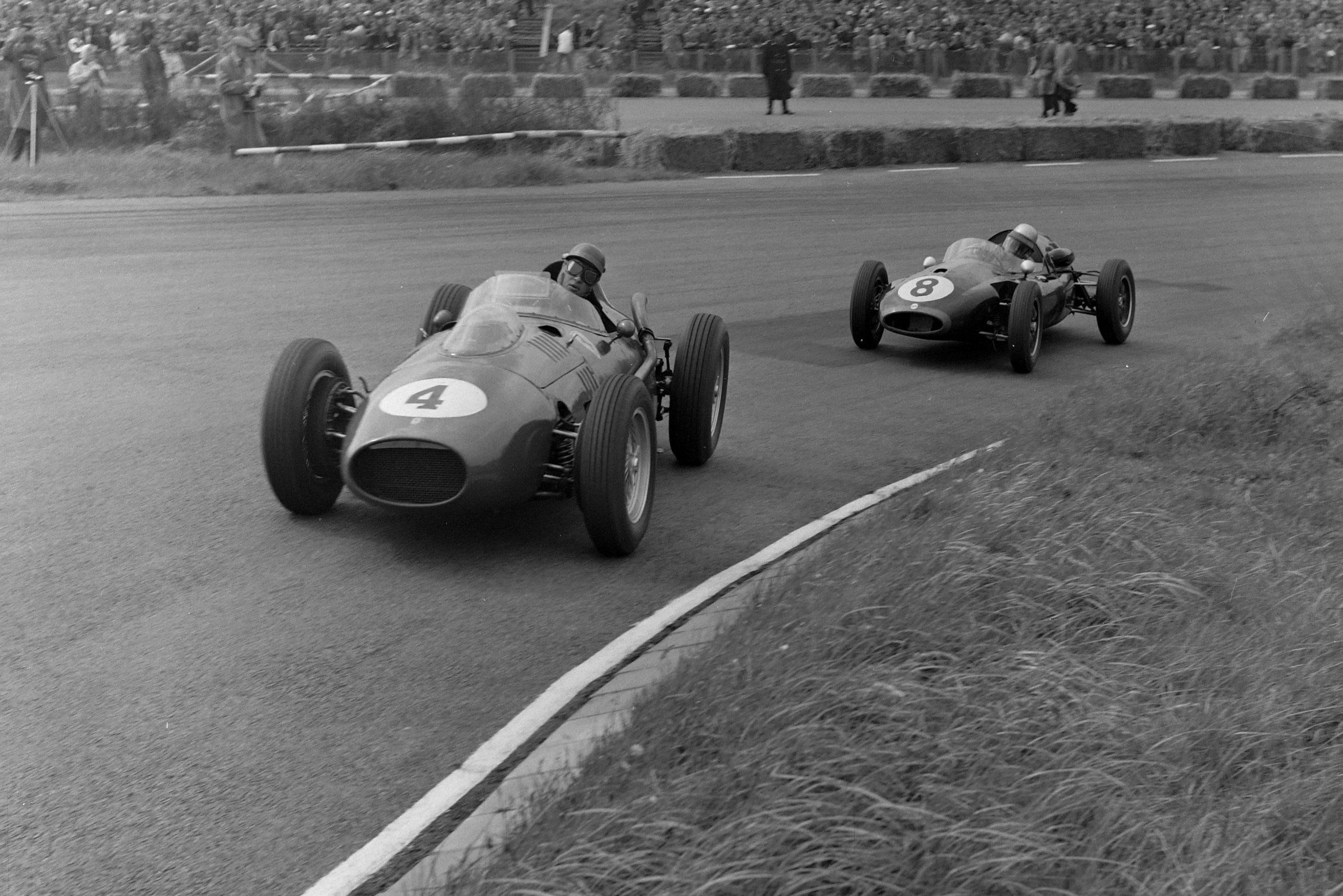 Peter Collins driving a Ferrari 246 ahead of Jack Brabham's Cooper T45 Climax.