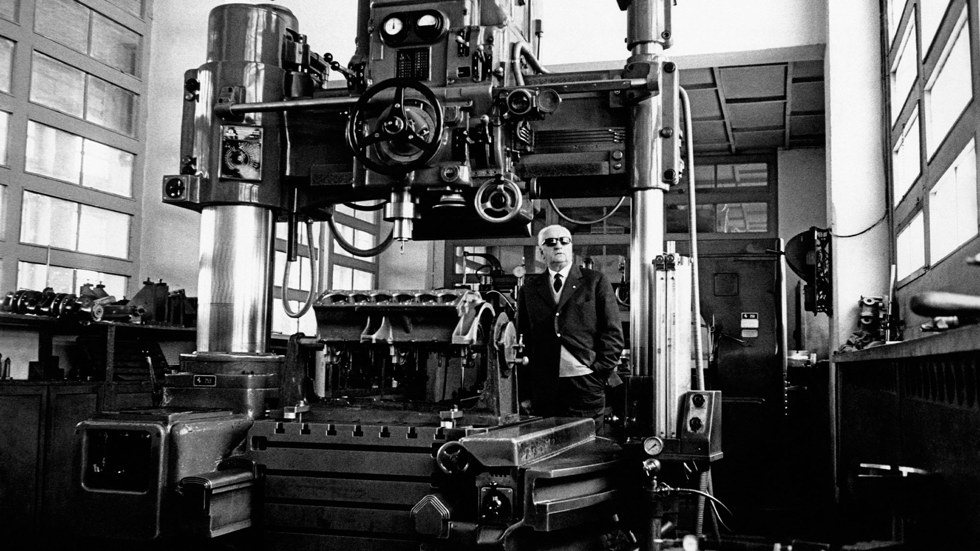 Italian entrepreneur and racing driver Enzo Ferrari posing beside a machinary in his factory. 1966 (Photo by Mondadori via Getty Images)