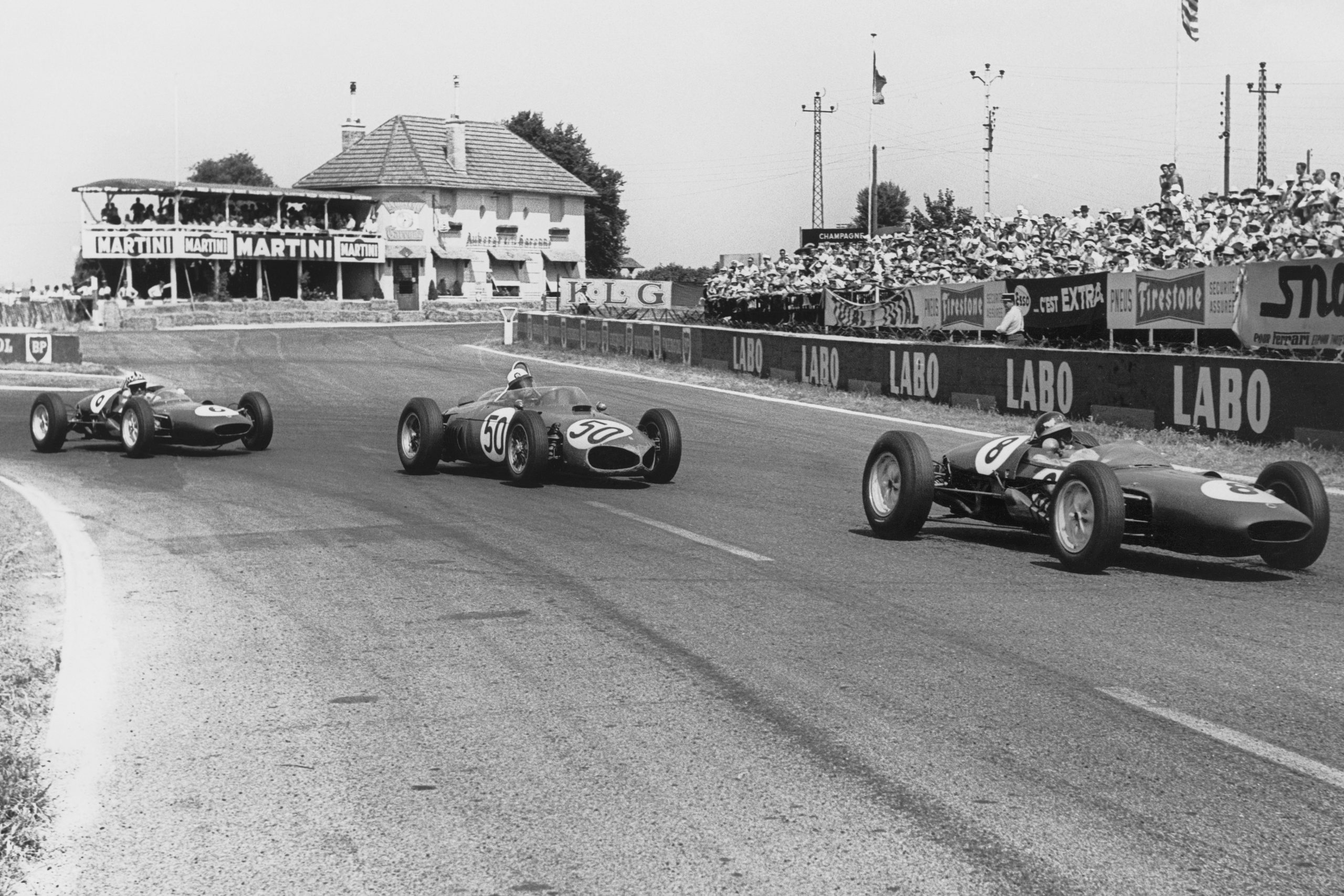 Jim Clark in a Lotus 21-Climax leads Giancarlo Baghetti in his Ferrari Dino 156 and Innes Ireland in a Lotus 21-Climax.