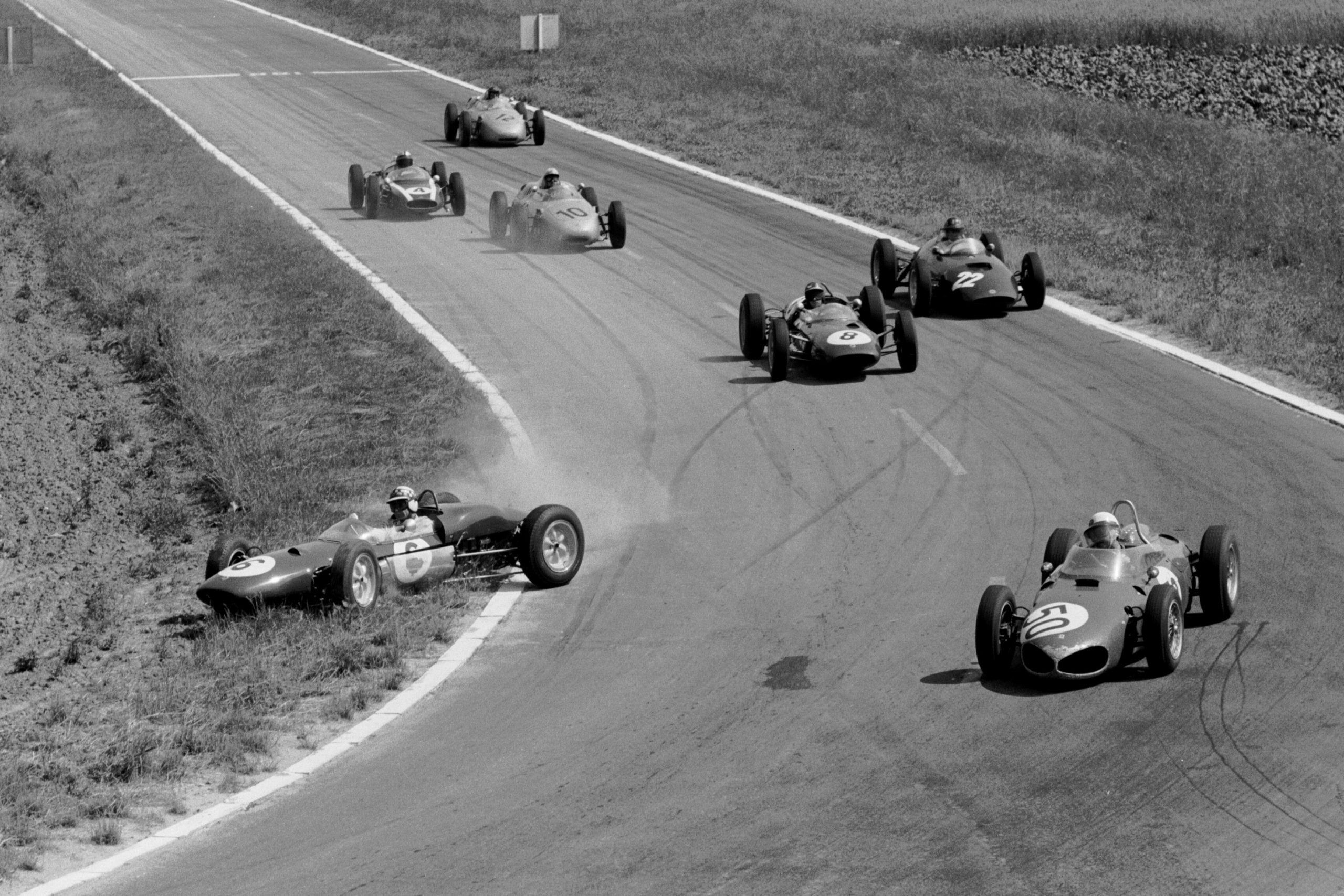 Winner Giancarlo Baghetti leads in the Ferrari 156, while Lotus 21 driver Innes Ireland gets it crossed up.
