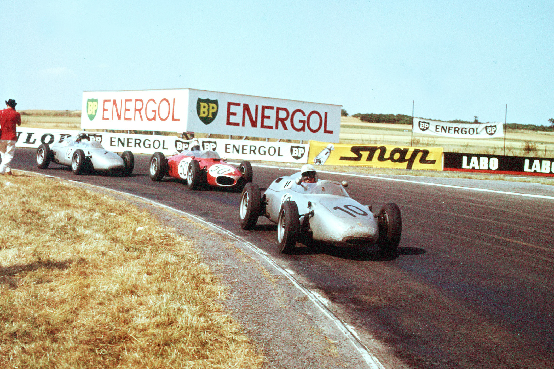 Jo Bonnier in a Porsche 718 leads Giancarlo Baghetti driving a Ferrari Dino 156 and Dan Gurney also in a Porsche 718.
