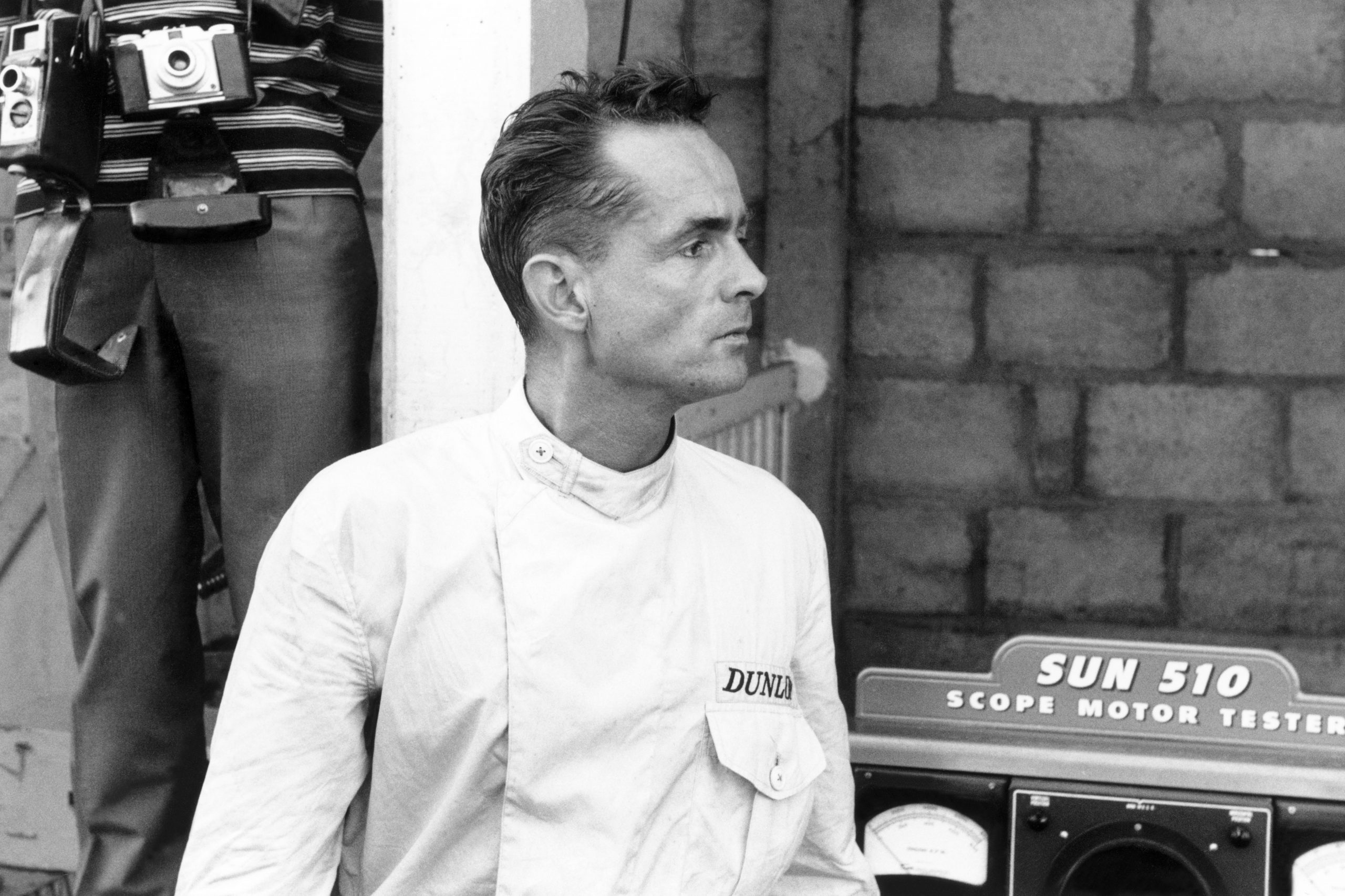 Ferrari 156 driver Phil Hill waits in the pits.