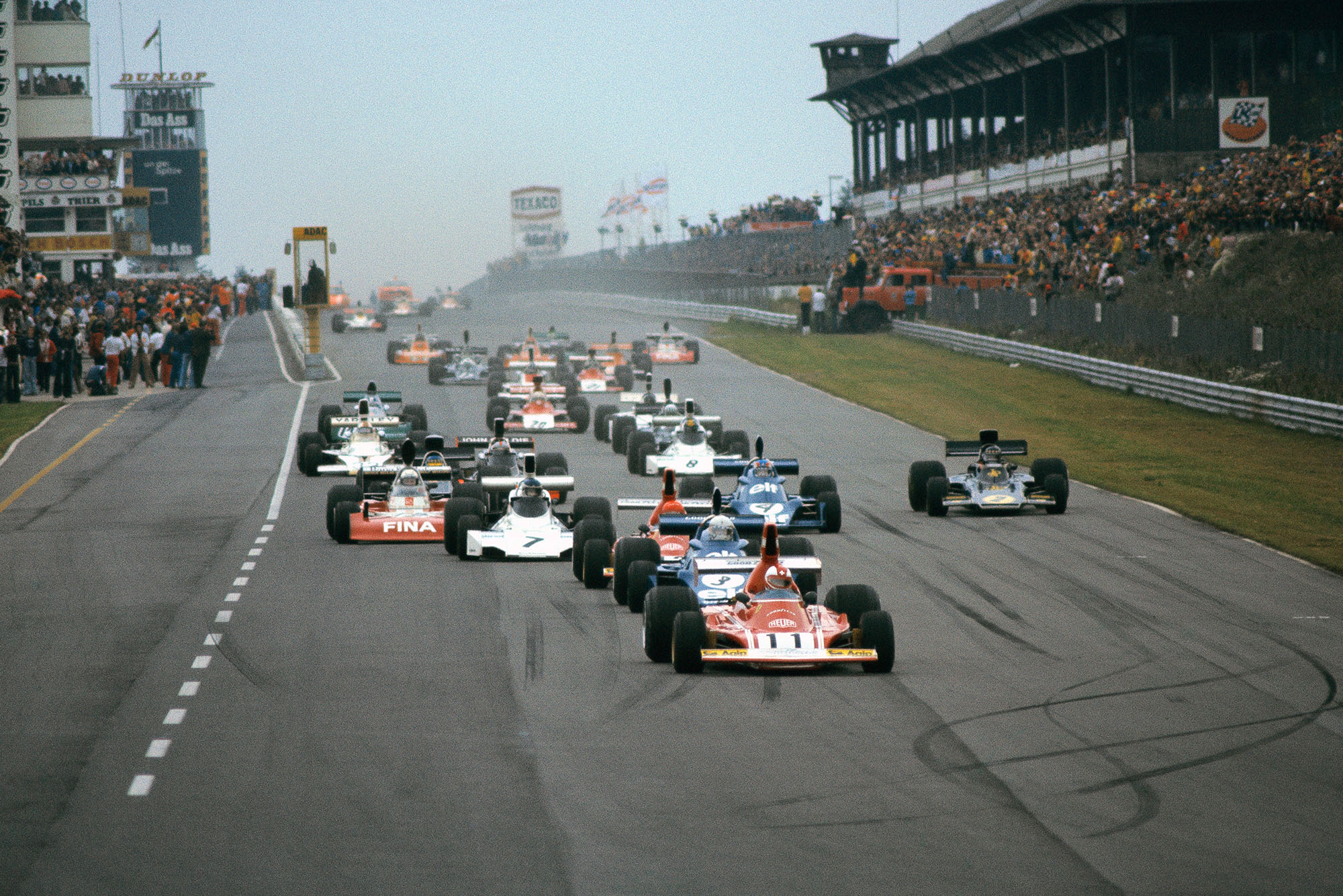 The cars head down to the first corner at the start of the 1974 Austrian Grand Prix.