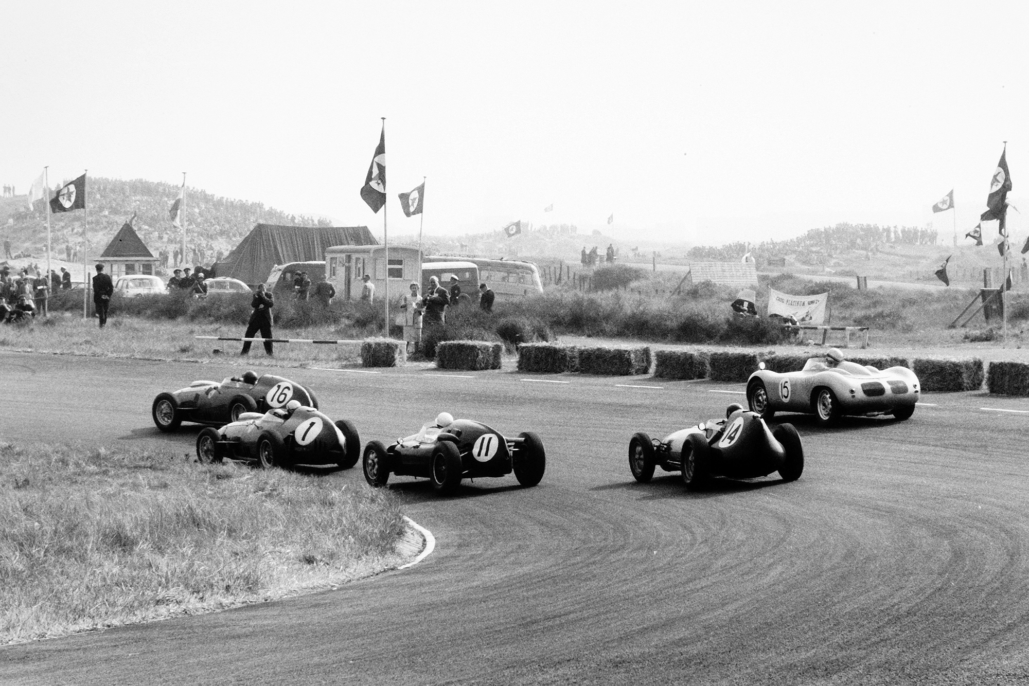 Cliff Allison in a Ferrari Dino 246, leads Jean Behra in his Ferrari Dino 246, Stirling Moss in a Cooper T51-Climax, Graham Hill in his Lotus 16-Climax, and Carel Godin de Beaufort in the Porsche RSK.