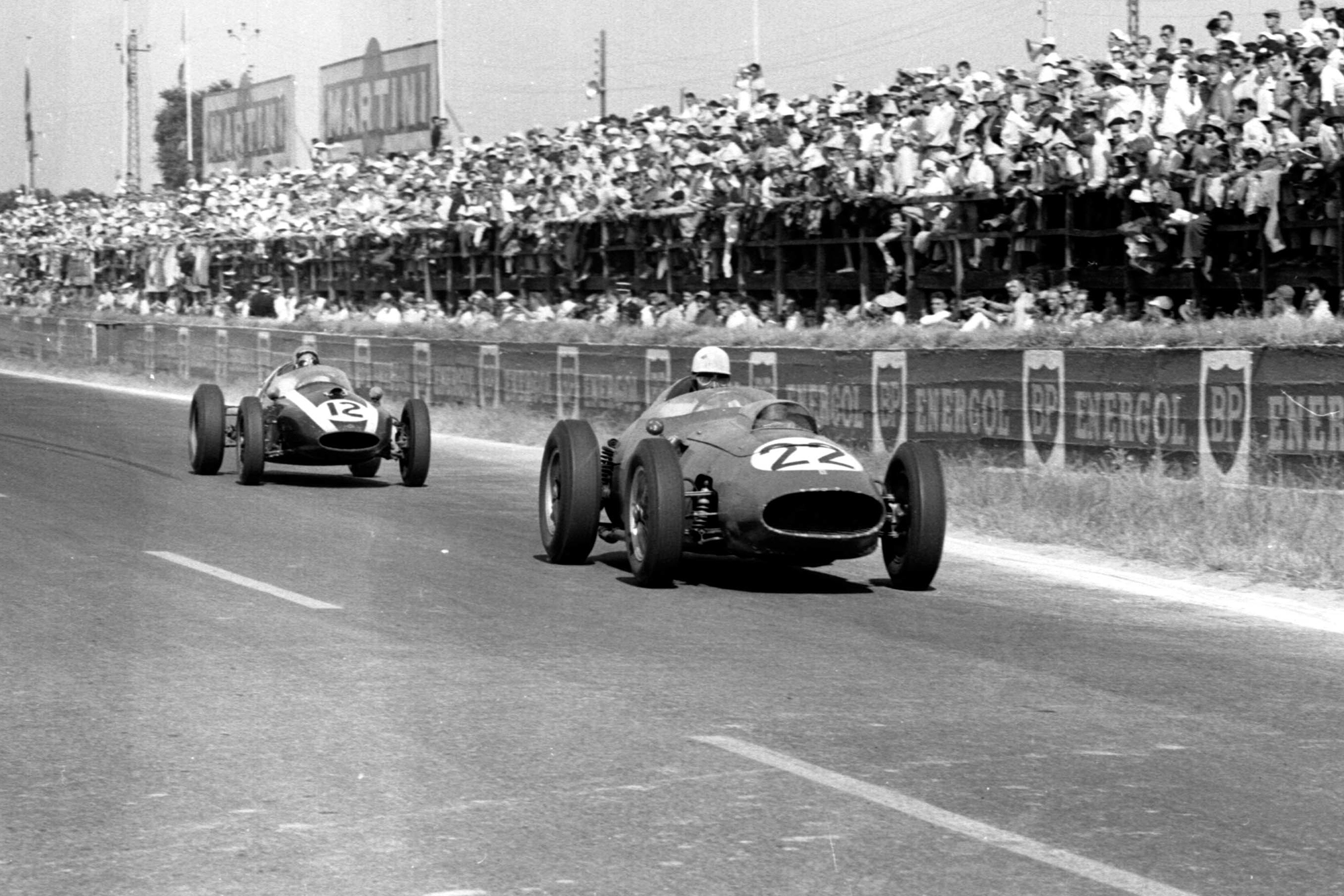 Olivier Gendebien in his Ferrari Dino 246 ahead of Bruce McLaren driving aCooper T45 Climax.