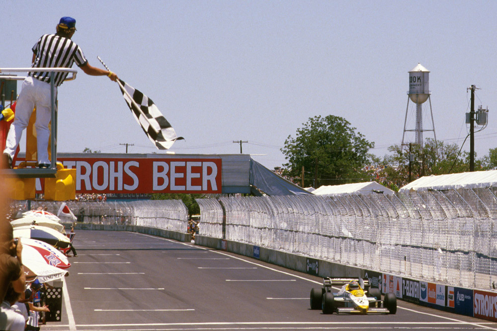 Keke Rosberg takes the chequered flag for the win.