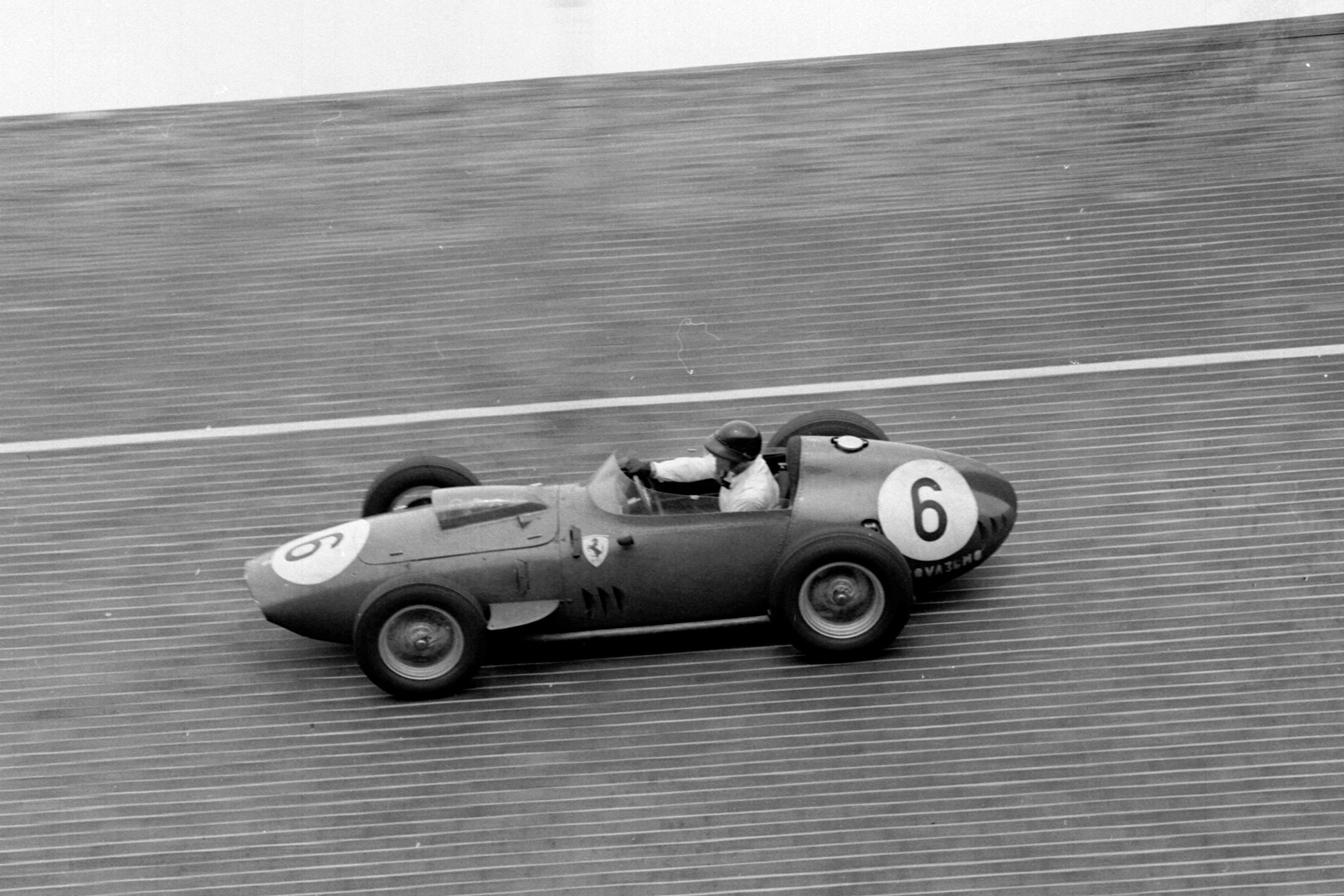 Dan Gurney takes his Ferrari Dino 246 around the banked North Turn.