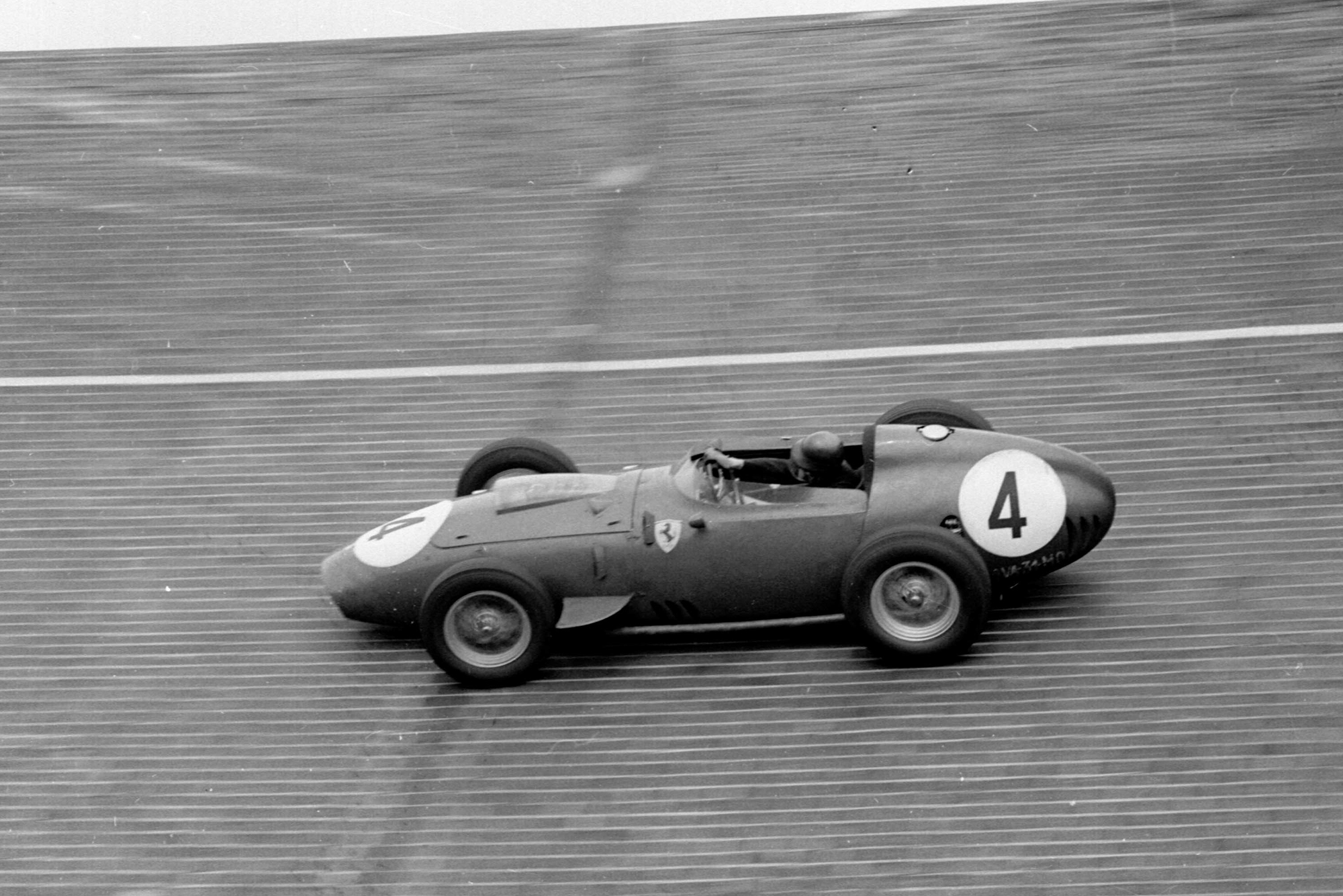 Tony Brooks' Ferrari Dino 246 on the banked North Turn.