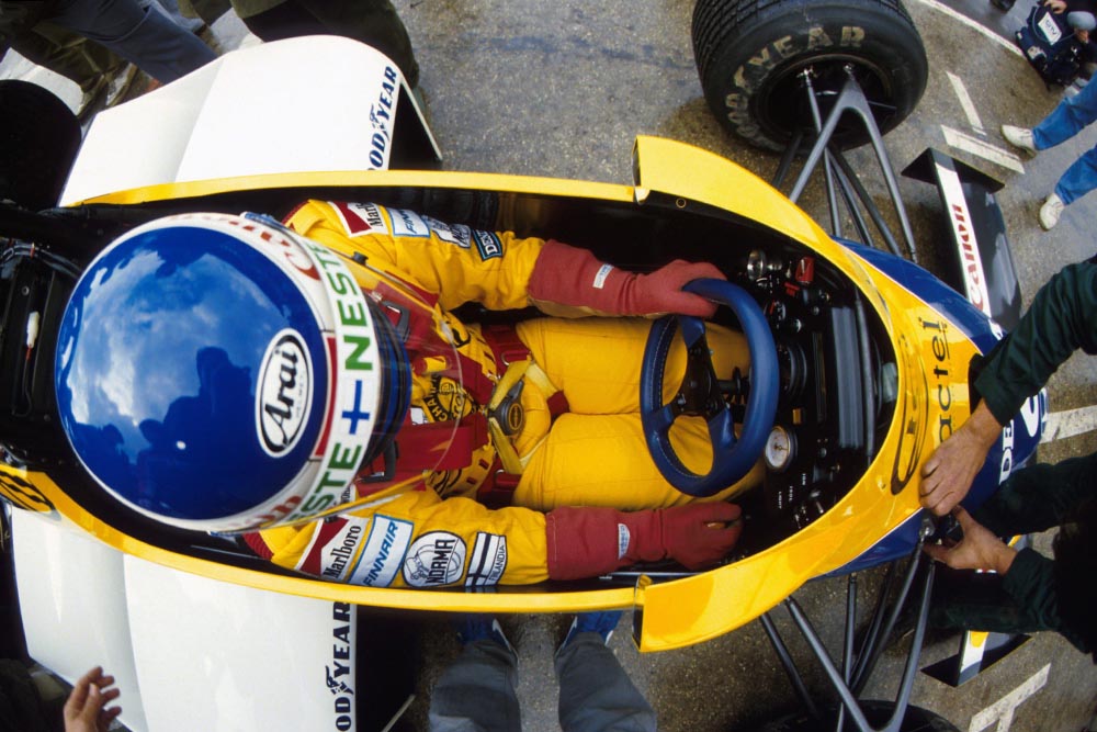 Keke Rosberg sitting in his Williams Honda FW10 .