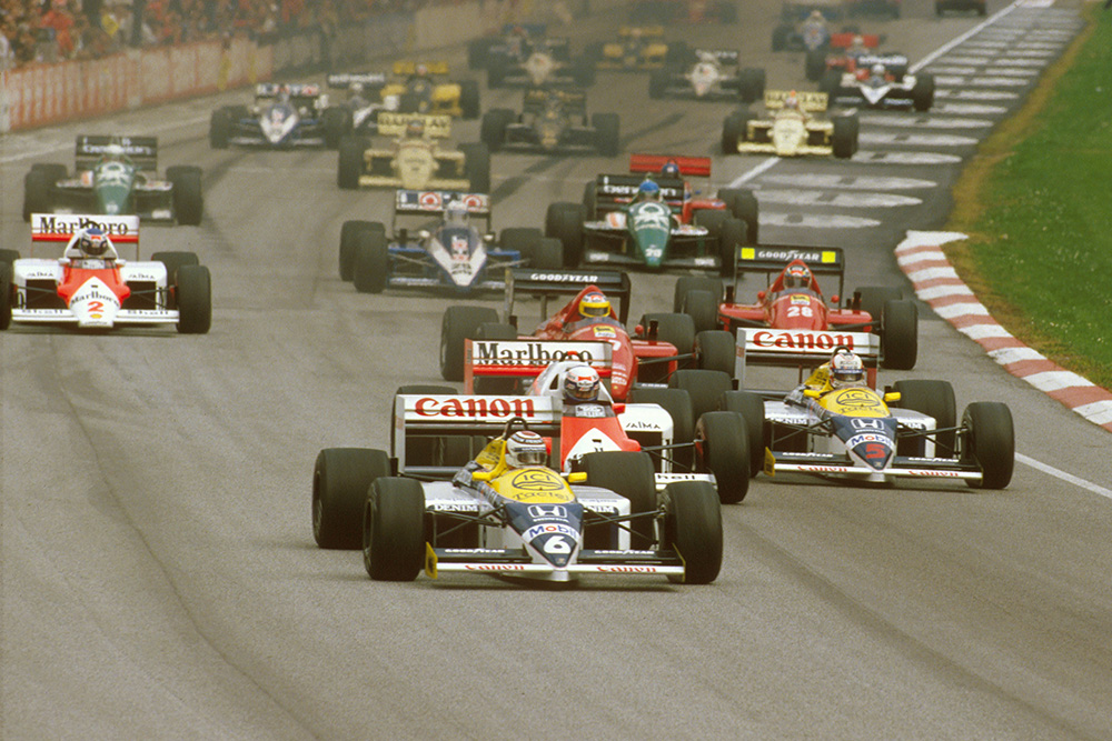 Nelson Piquet (Williams FW11 Honda) leads Alain Prost (McLaren MP4/2C TAG Porsche), Nigel Mansell (Williams FW11 Honda), Michele Alboreto and Gerhard Berger (both Ferrari F186's) at the start.