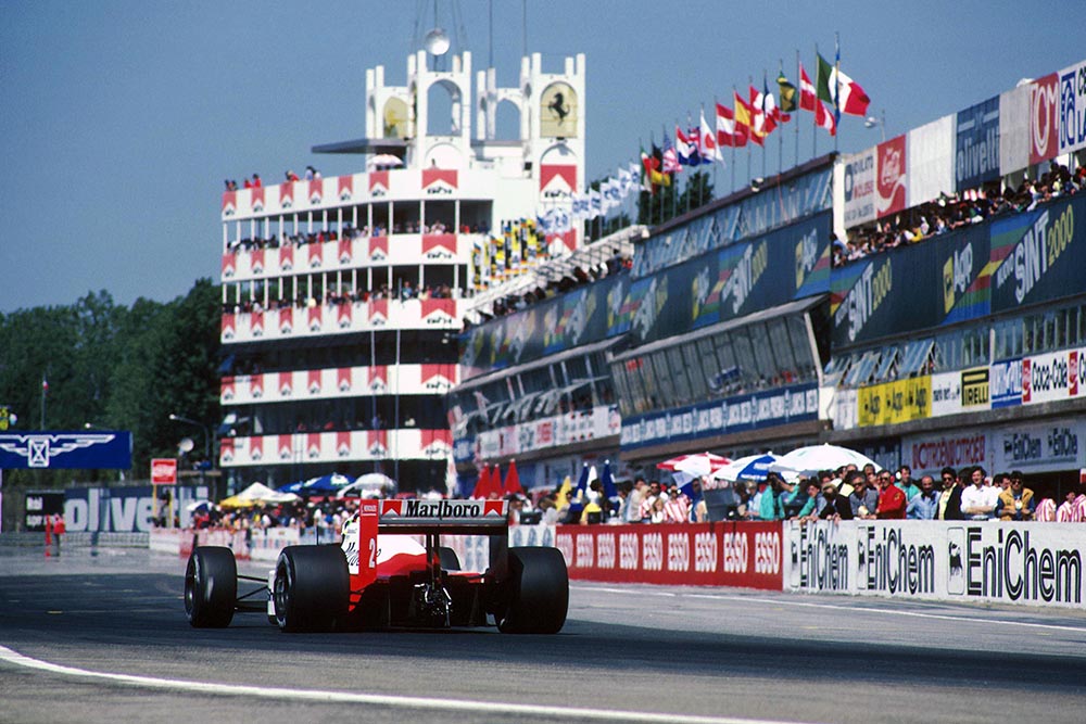 Stefan Johansson in his McLaren MP4-3, passes the Imola pits on his way to 4th place.