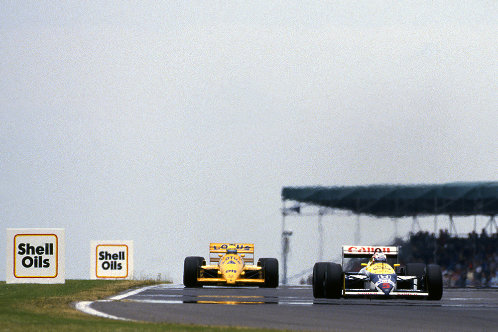 Nigel Mansell, Williams FW11B, leads Ayrton Senna, Lotus 99T.