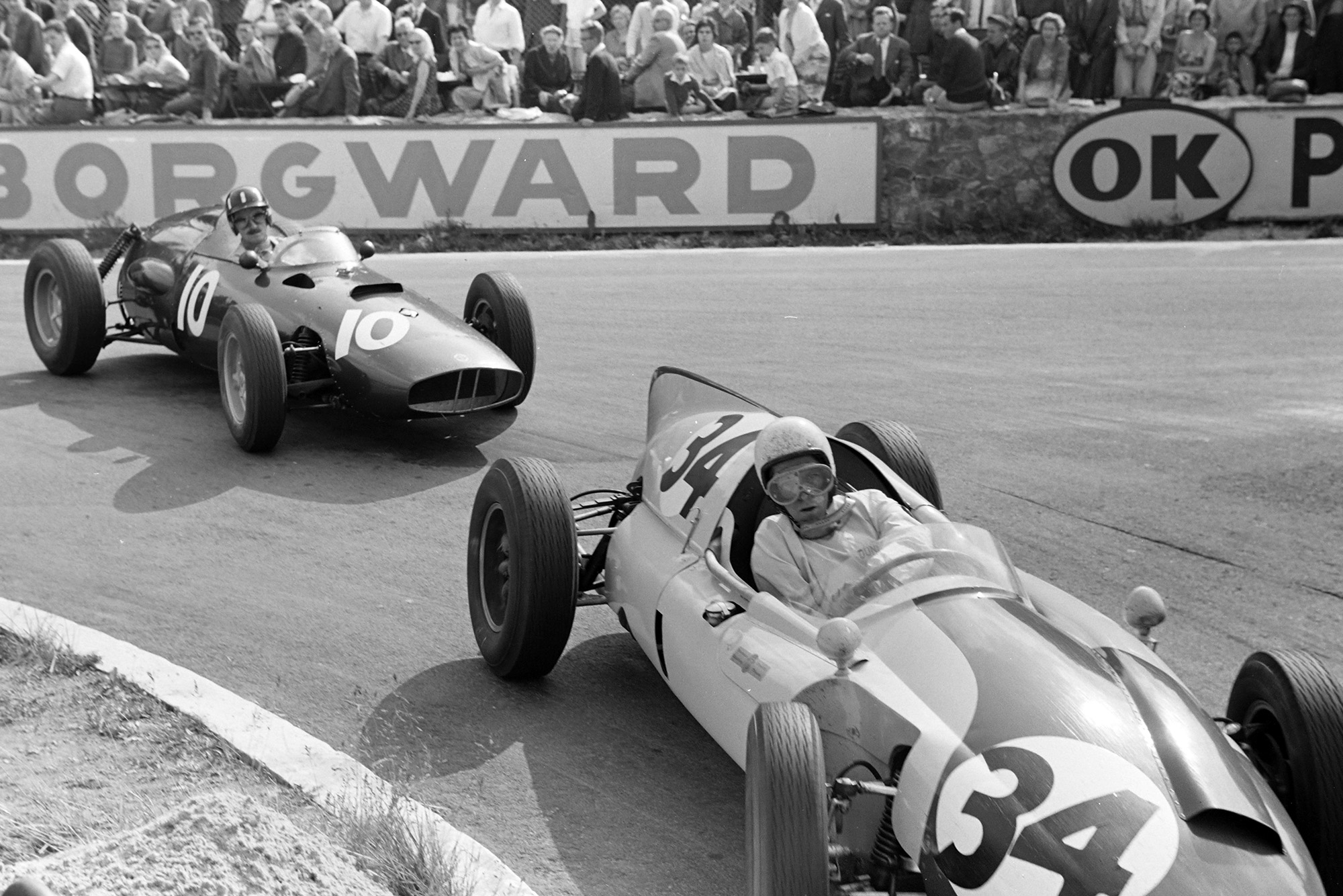 Hill, seen here dicing with Gendbien, ran as high as 3rd before retiring