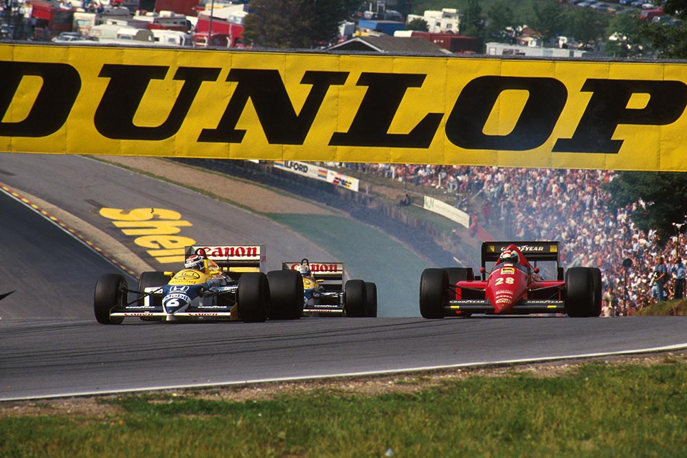Nelson Piquet (Williams FW11) passes the Ferrari F186 of Stefan Johansson.