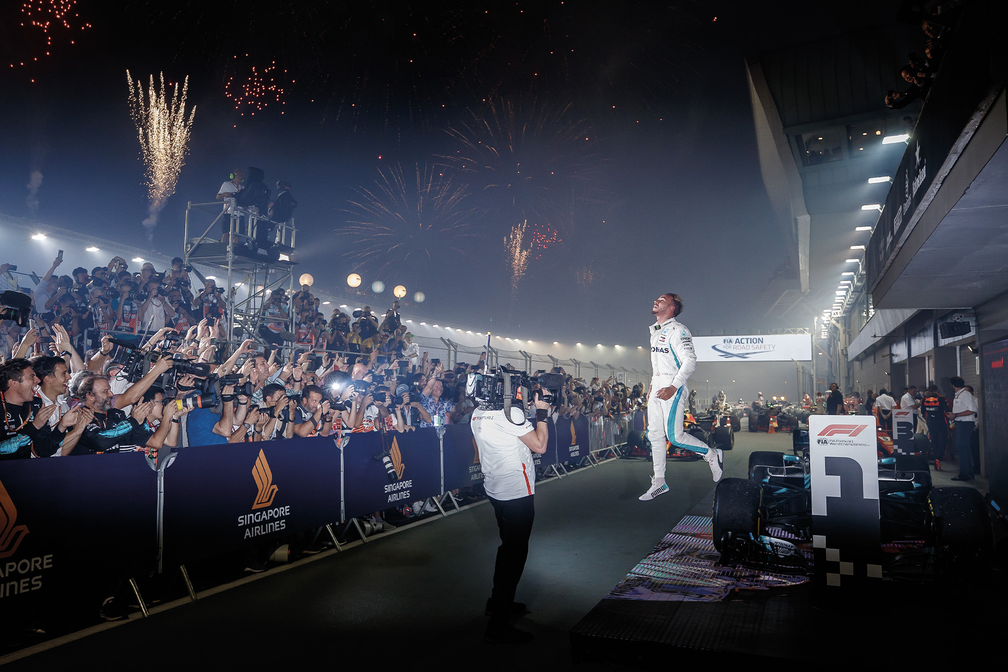 Hamilton leaps off his car after victory in Singapore