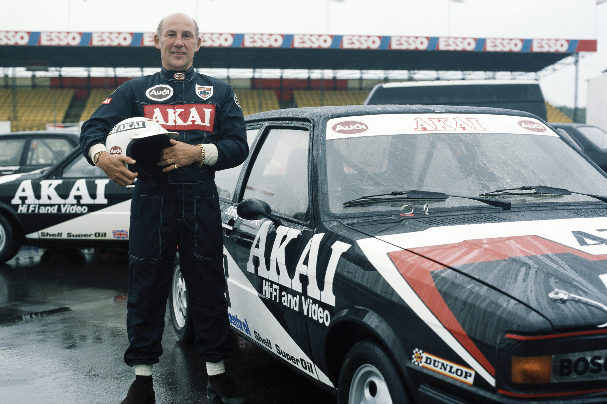 Stirling Moss next to his Audi Touring Car in 1980