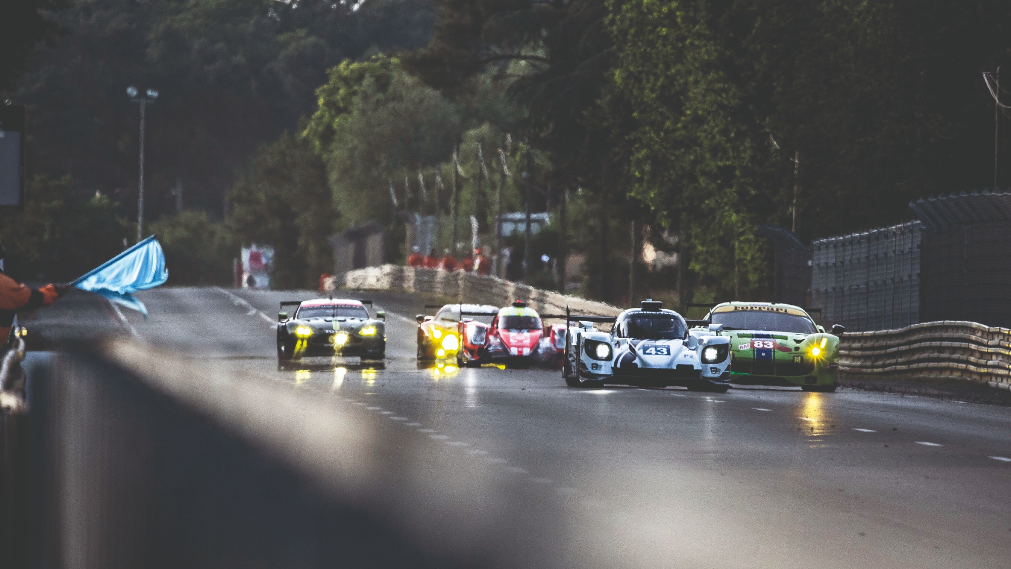 The #43 Keating Riley LMP2 driven by Jeroen Bleekemolen of the Netherlands, and Ben Keating and Ricky Taylor of the USA, passes the #83 DH Racing Ferrari 488 GTE AM on the Mulsanne Straight during qualifying for the 2017 Le Mans 24 Hours