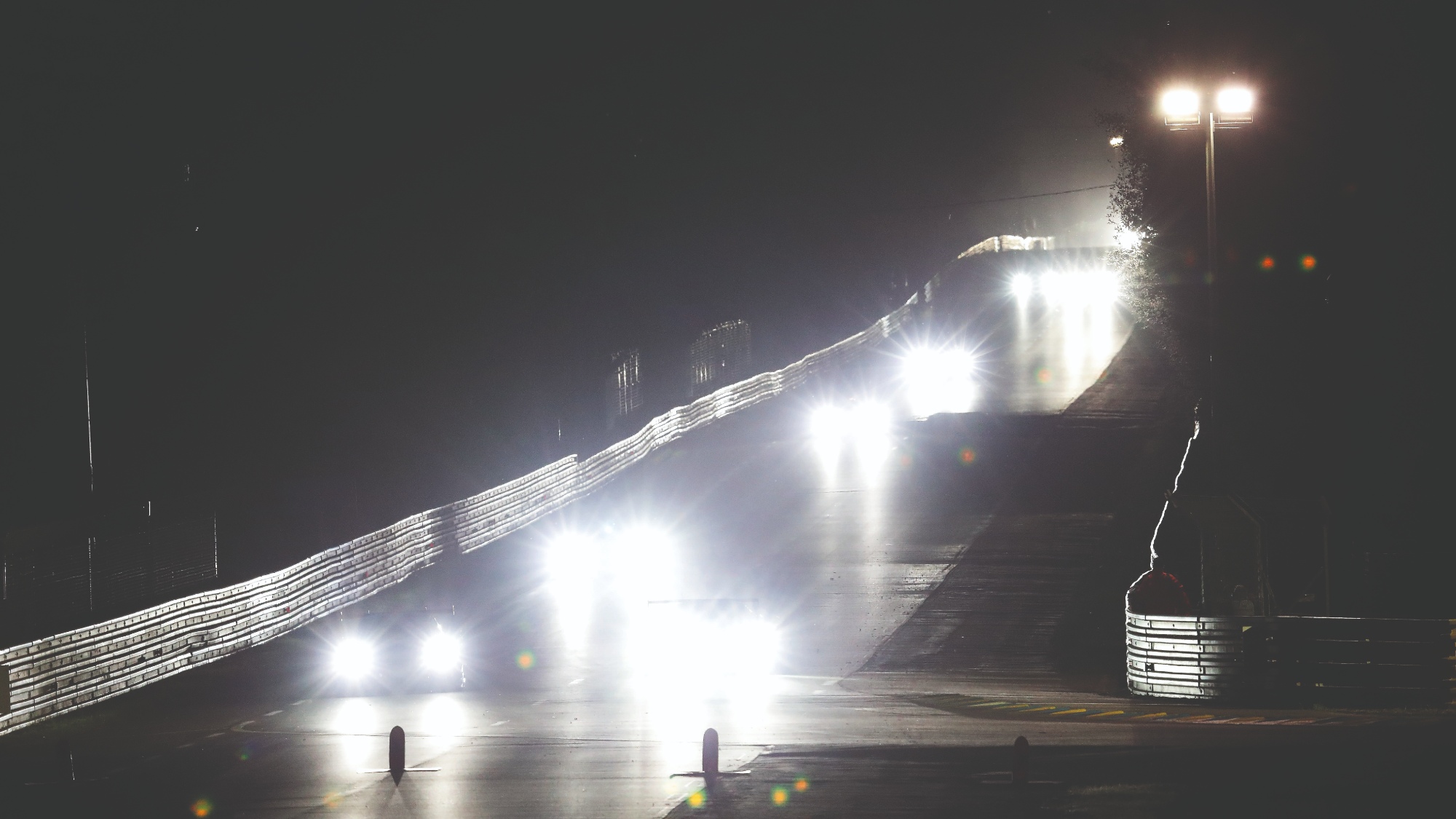 Headlight beams from cars racing at night during the Le Mans 24 Hours