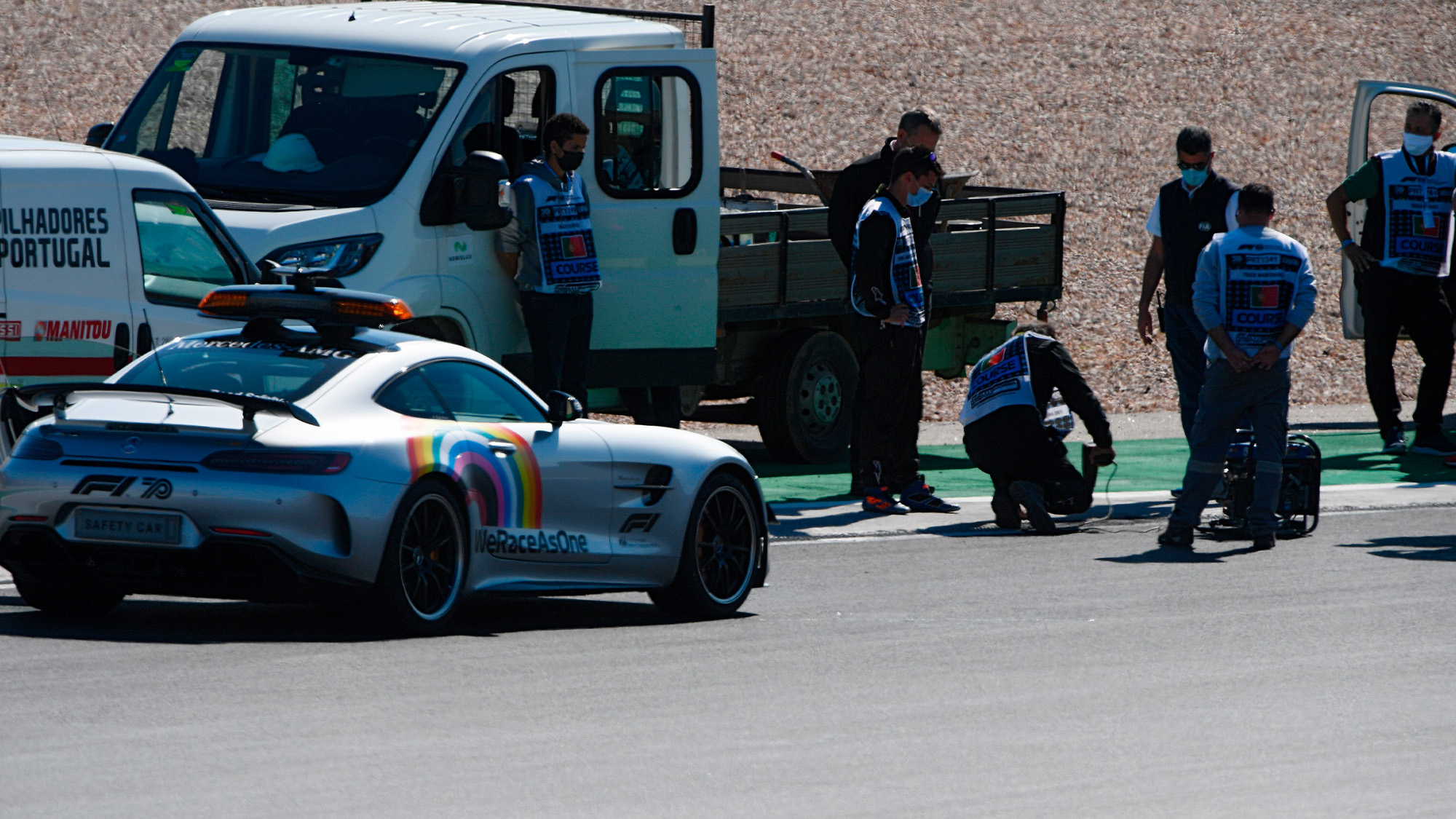 Engineers inspect drain covers on the circuit at Portimao ahead of qualifying for the 2020 Portuguese Grand prix