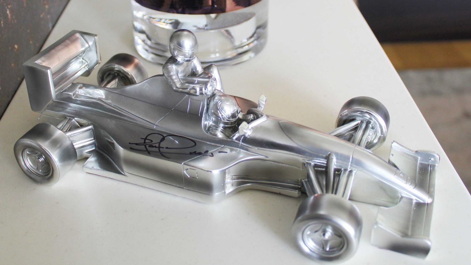 Taxi for Senna chrome sculpture, signed by Nigel Mansell