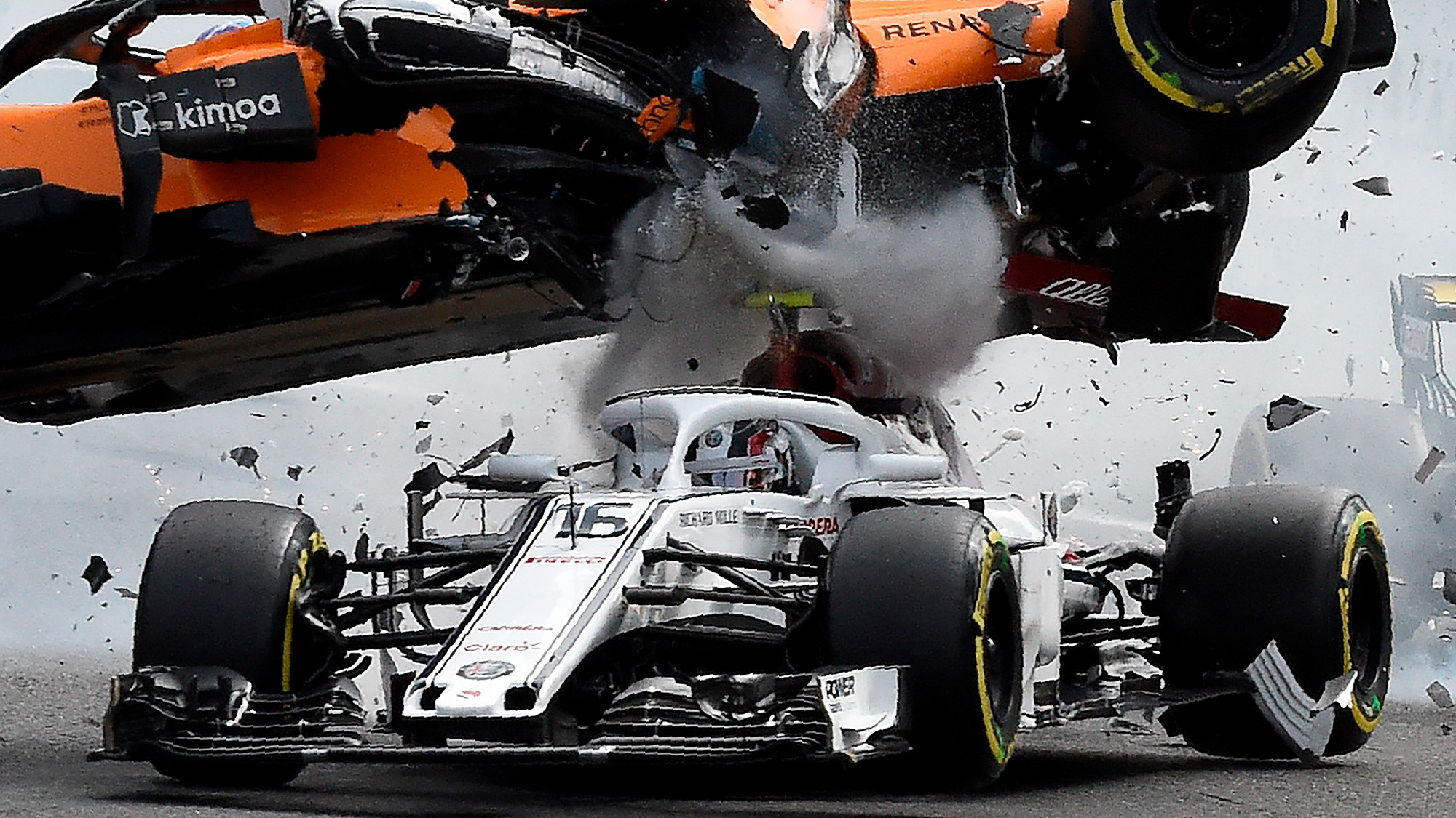 Fernando Alonso's McLaren flies over the Alfa Romeo of Charles Leclerc at the 2018 Belgian Grand Prix