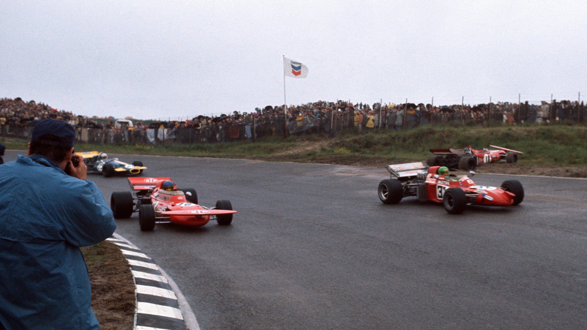 Pescarolo, Peterson and Schenken pass the crashed car of Nanni Galli at the 1971 Dutch GP